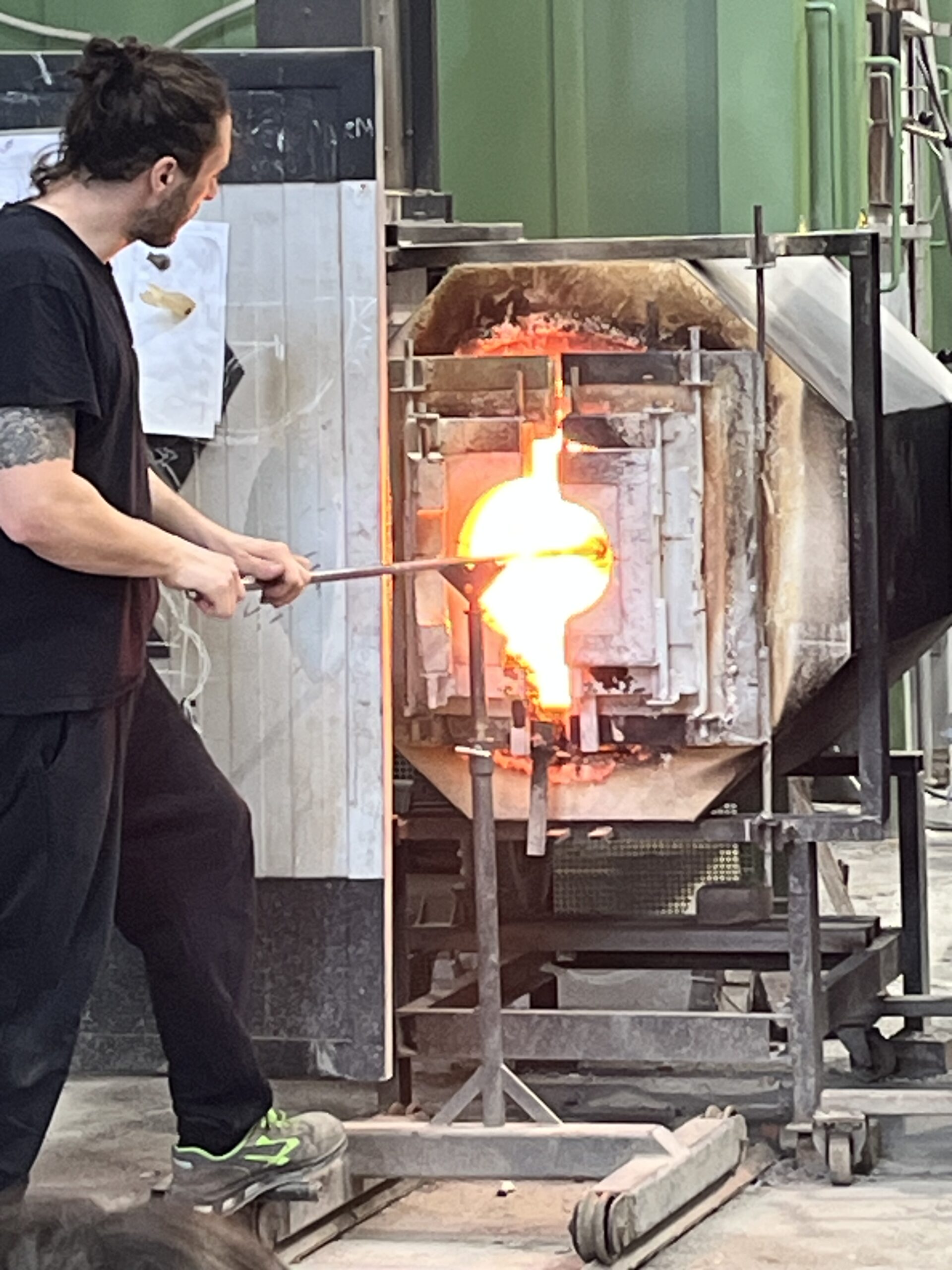 Glass artist working with molten glass